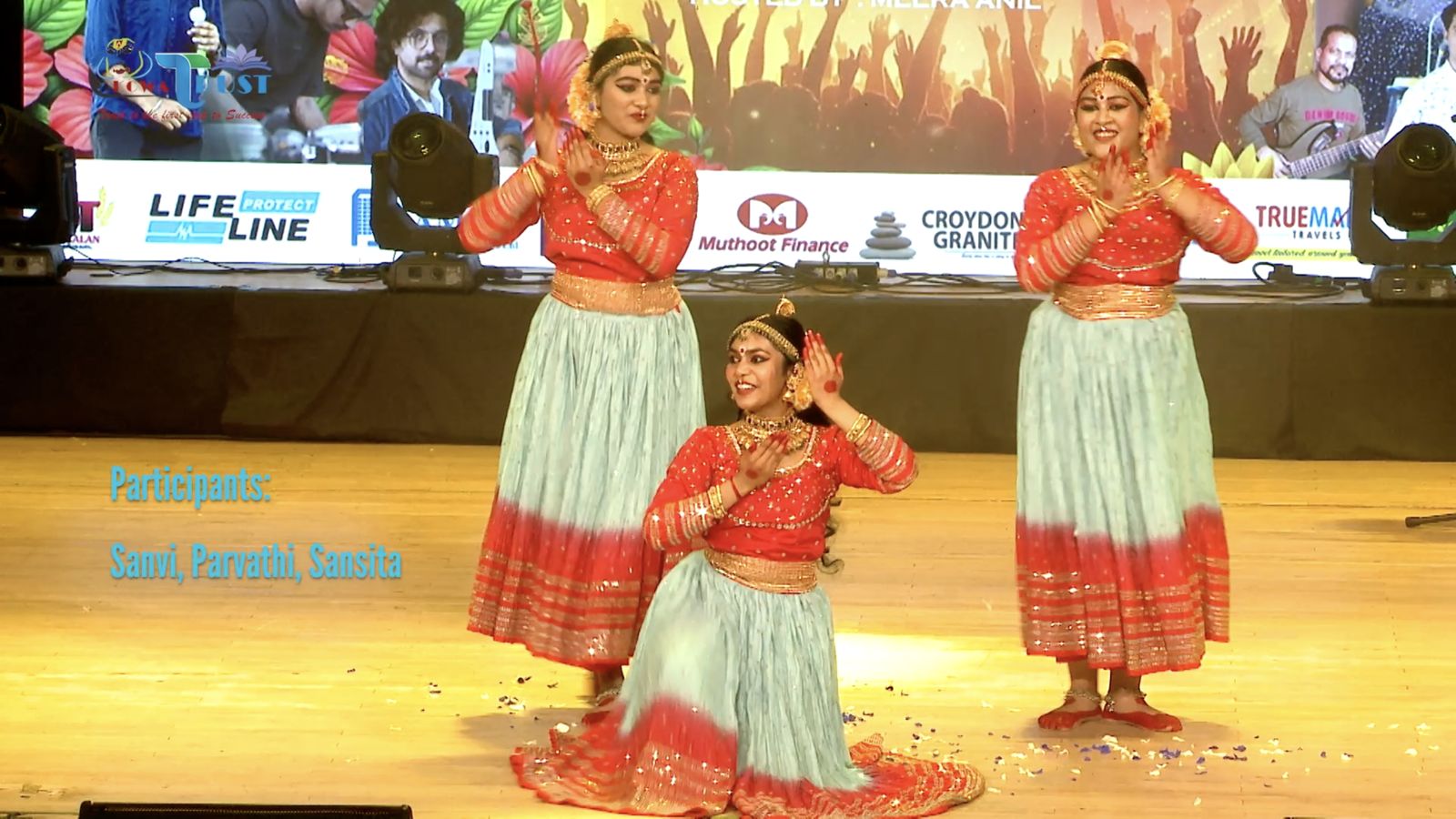 Dancers on stage with sponsor artwork on the LED wall